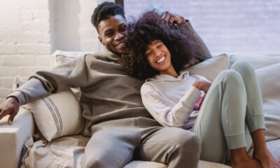 black couple laughing on couch on date night at home